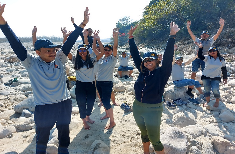 Participants celebrating during an outdoor corporate learning programme