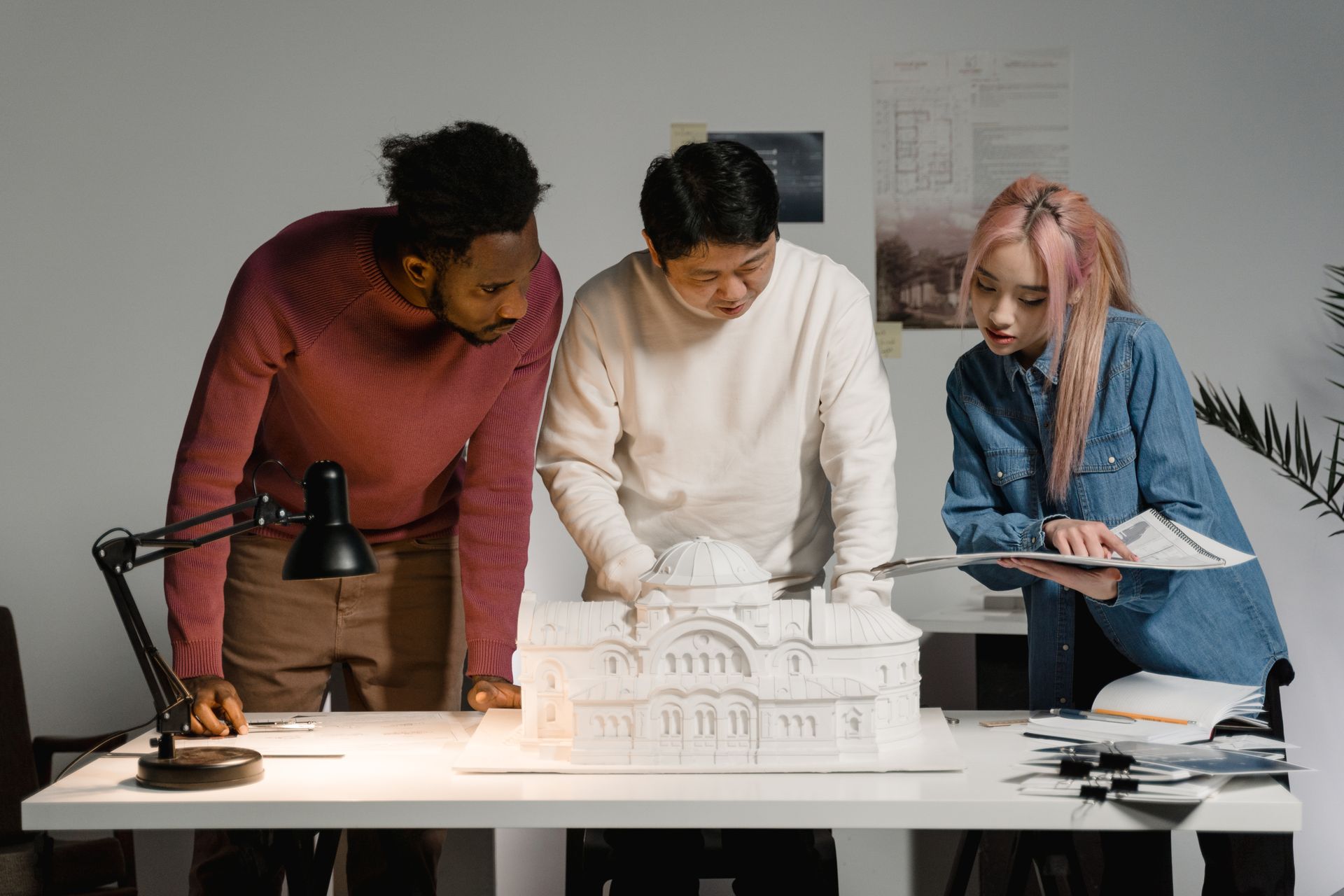 Three colleagues collaborating over a shared project