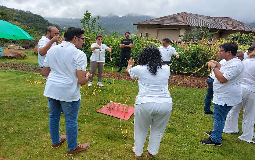 Participants working together on an outdoor experiential team exercise
