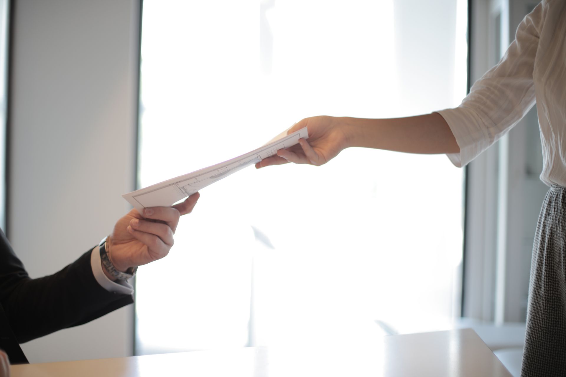 A CV being handed from one person to another